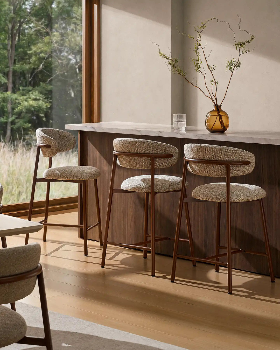 Three Rowan Walnut Bar Stools around a kitchen island with walnut finish