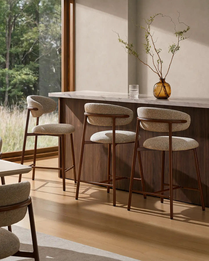 Three Rowan Walnut Bar Stools around a kitchen island with walnut finish