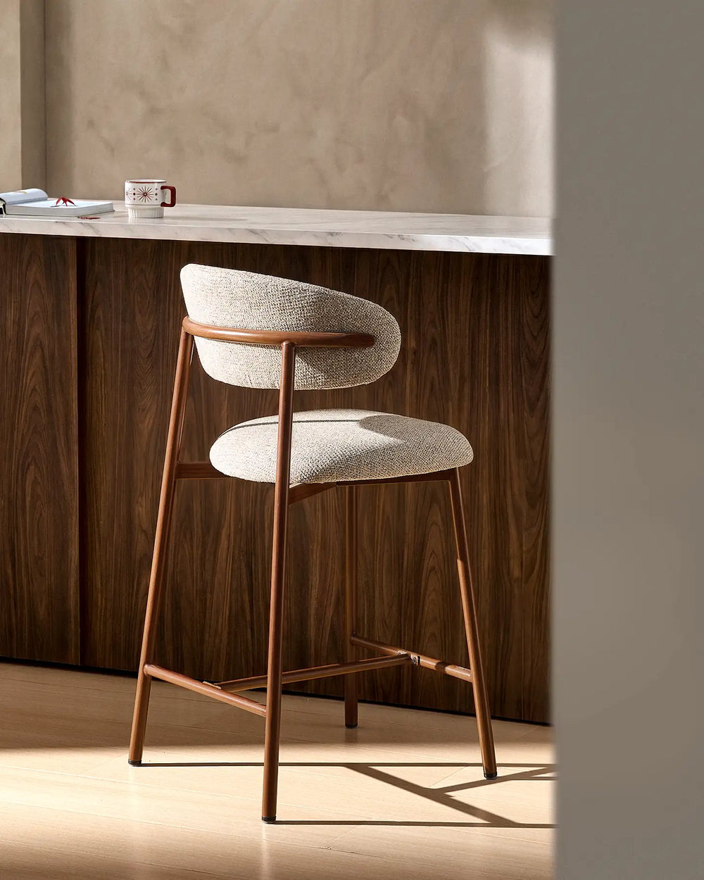 Rowan Walnut Bar Stool at a kitchen island, rear side view