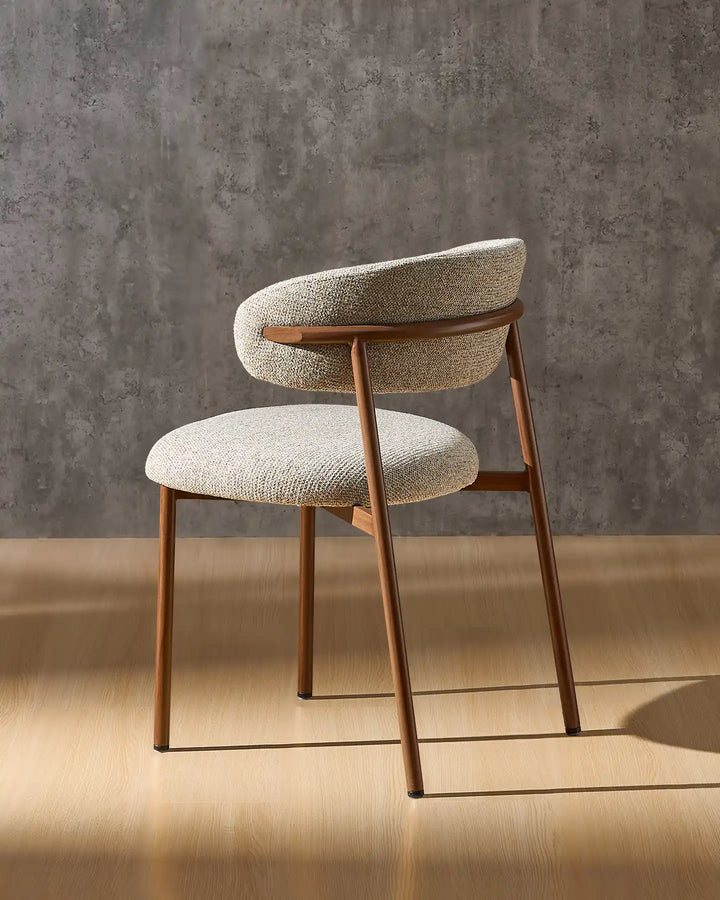 Rowan farmhouse dining chair angled view highlighting the upholstered design and walnut-effect frame