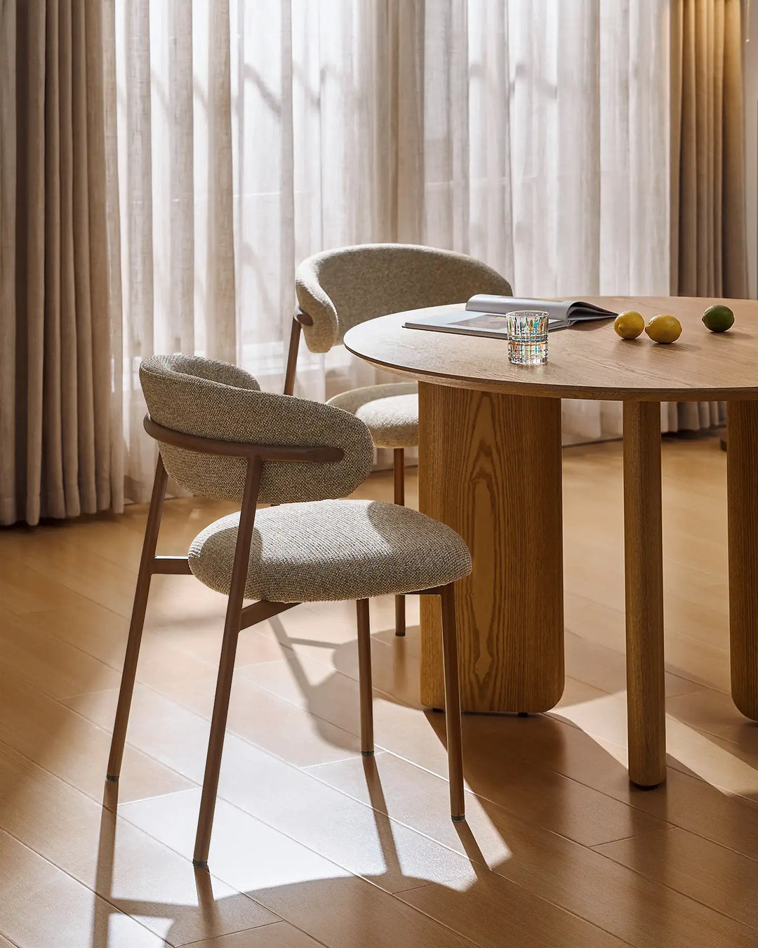 Detail of the Rowan walnut-effect dining chair showing the smooth transition between the backrest and walnut-effect legs