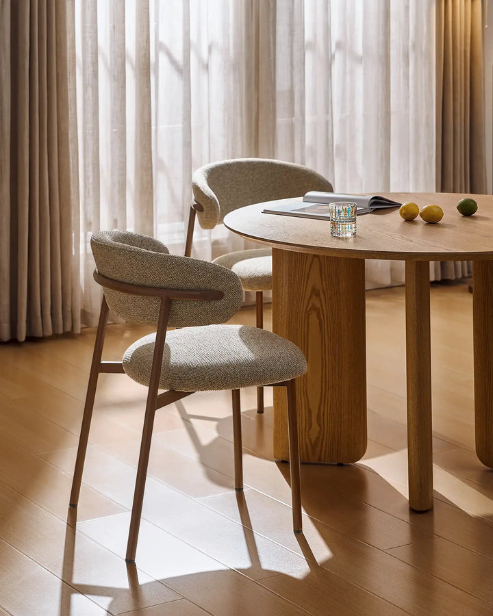 Detail of the Rowan walnut-effect dining chair showing the smooth transition between the backrest and walnut-effect legs