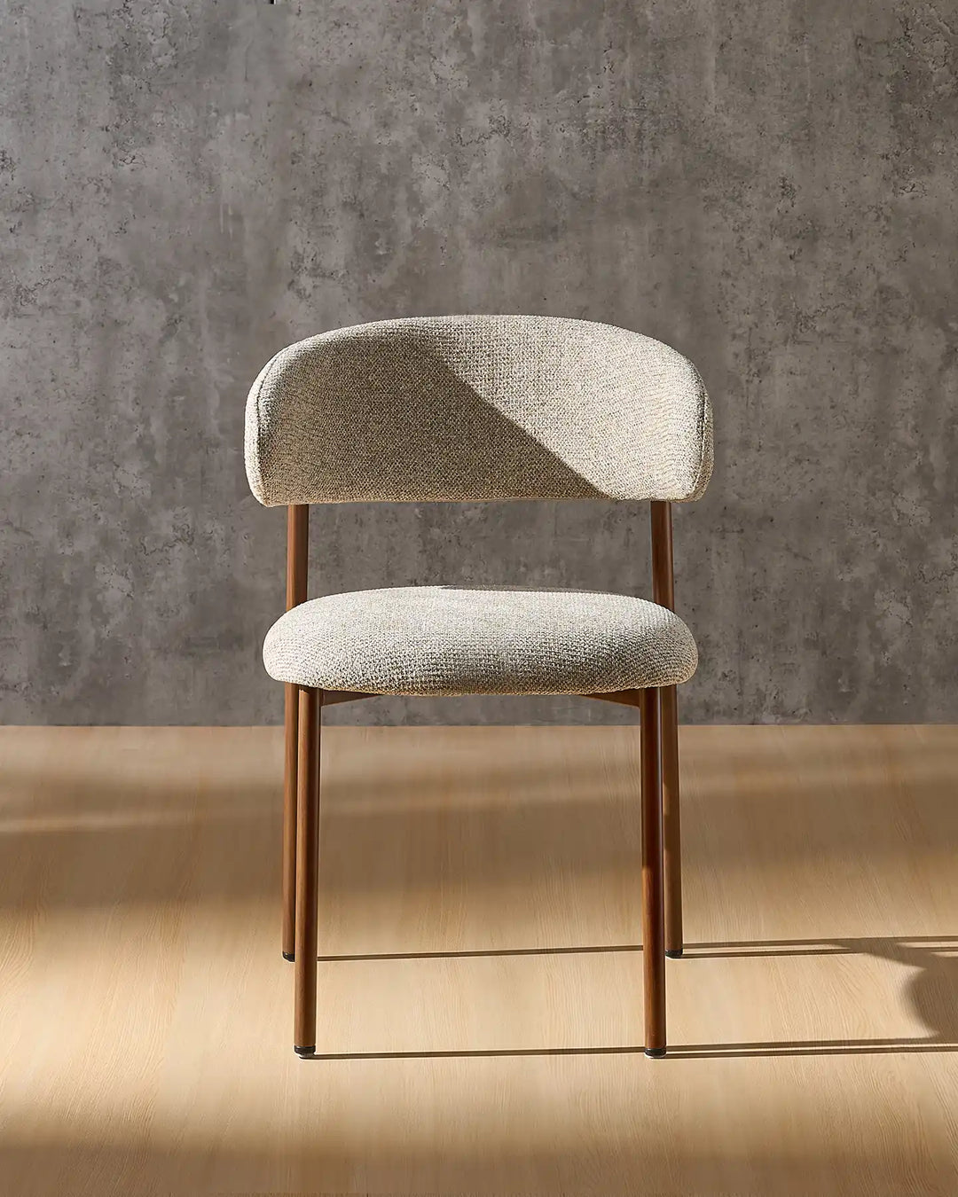 Rowan walnut dining chair front view with upholstered seat, curved backrest and walnut-effect legs