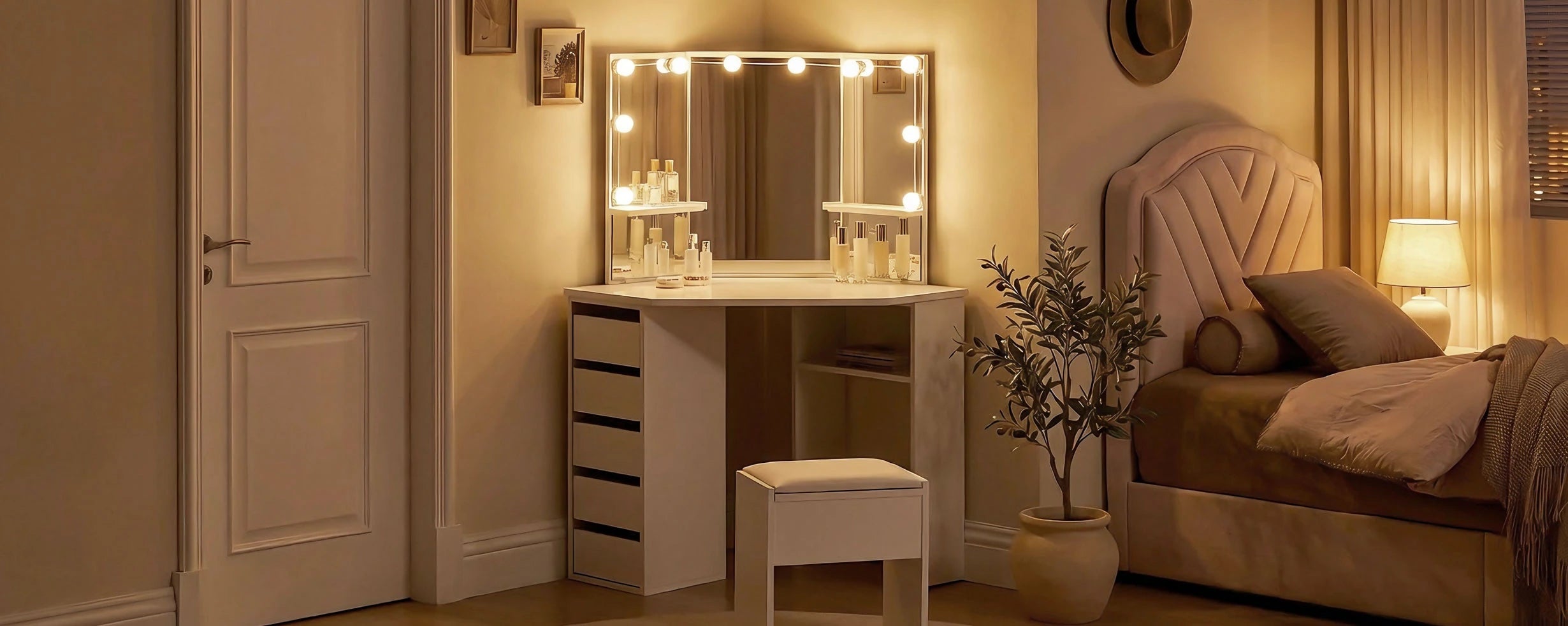Roze white corner dressing table with LED lights and stool in a bedroom at night, warm lighting switched on
