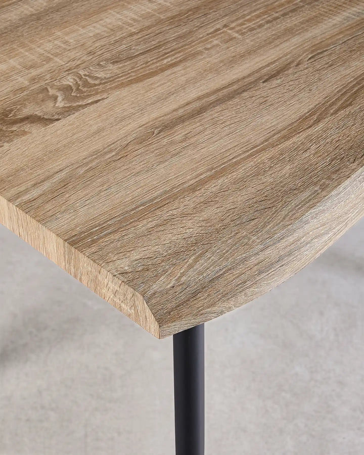 Close-up of the Seibold dining table corner showing the organically shaped live edge and natural wood grain