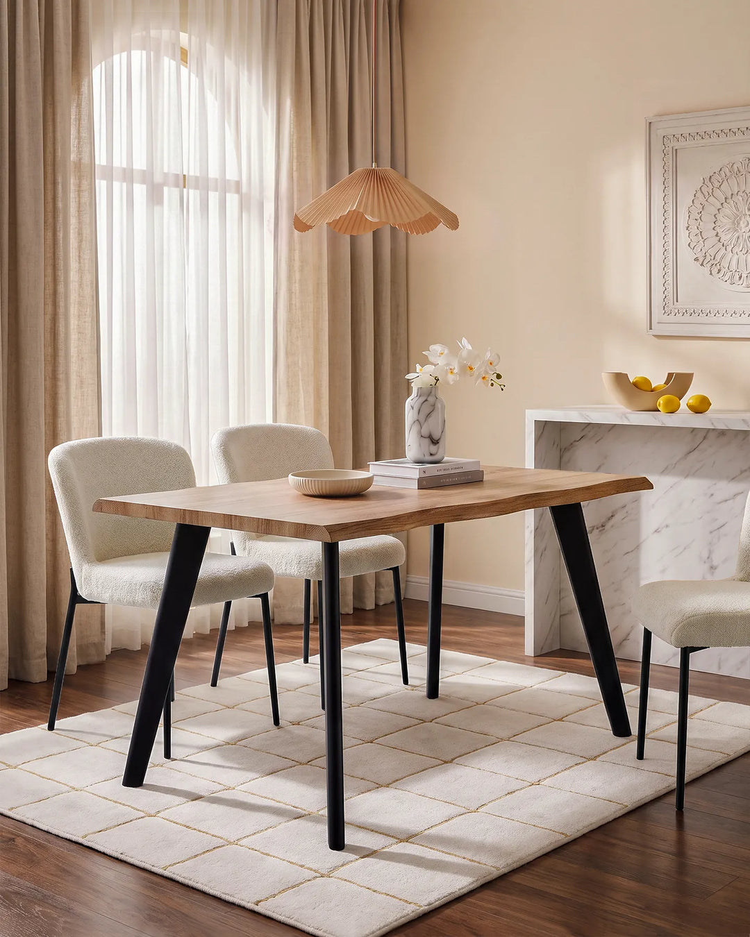 Seibold live edge dining table styled with upholstered dining chairs, rug and neutral decor in a bright dining room