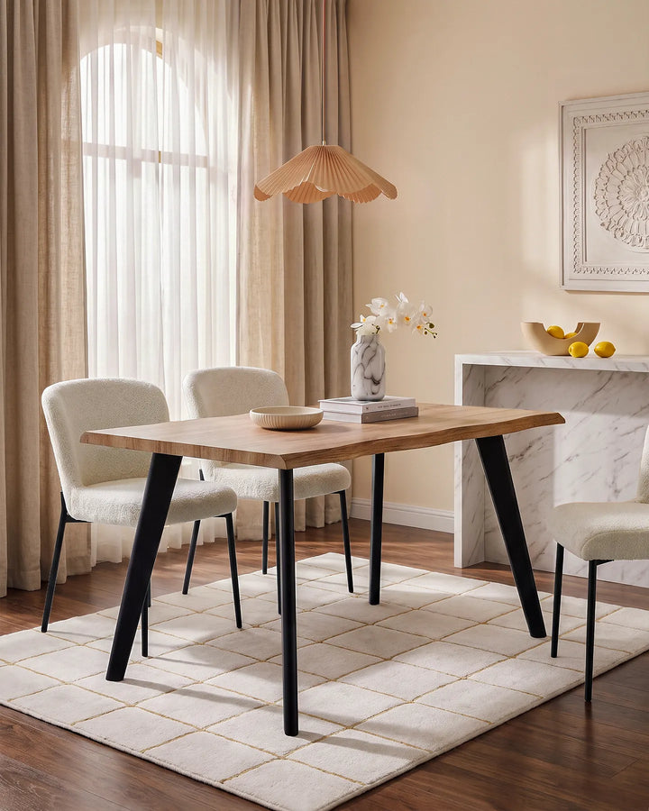 Seibold live edge dining table styled with upholstered dining chairs, rug and neutral decor in a bright dining room