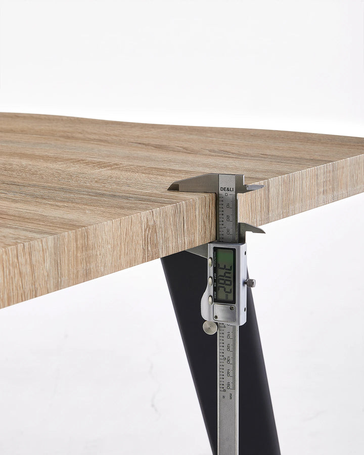 Close-up of the Seibold live edge tabletop showing the textured wood-effect edge and black leg connection