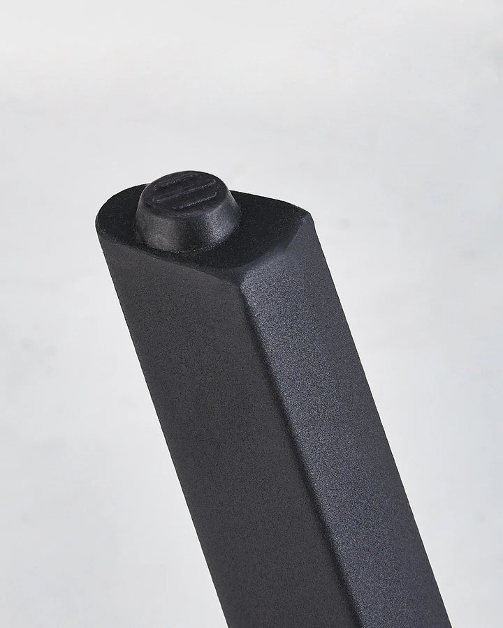 Close-up of the Seibold dining table leg showing the black foot pad and sturdy tapered leg design
