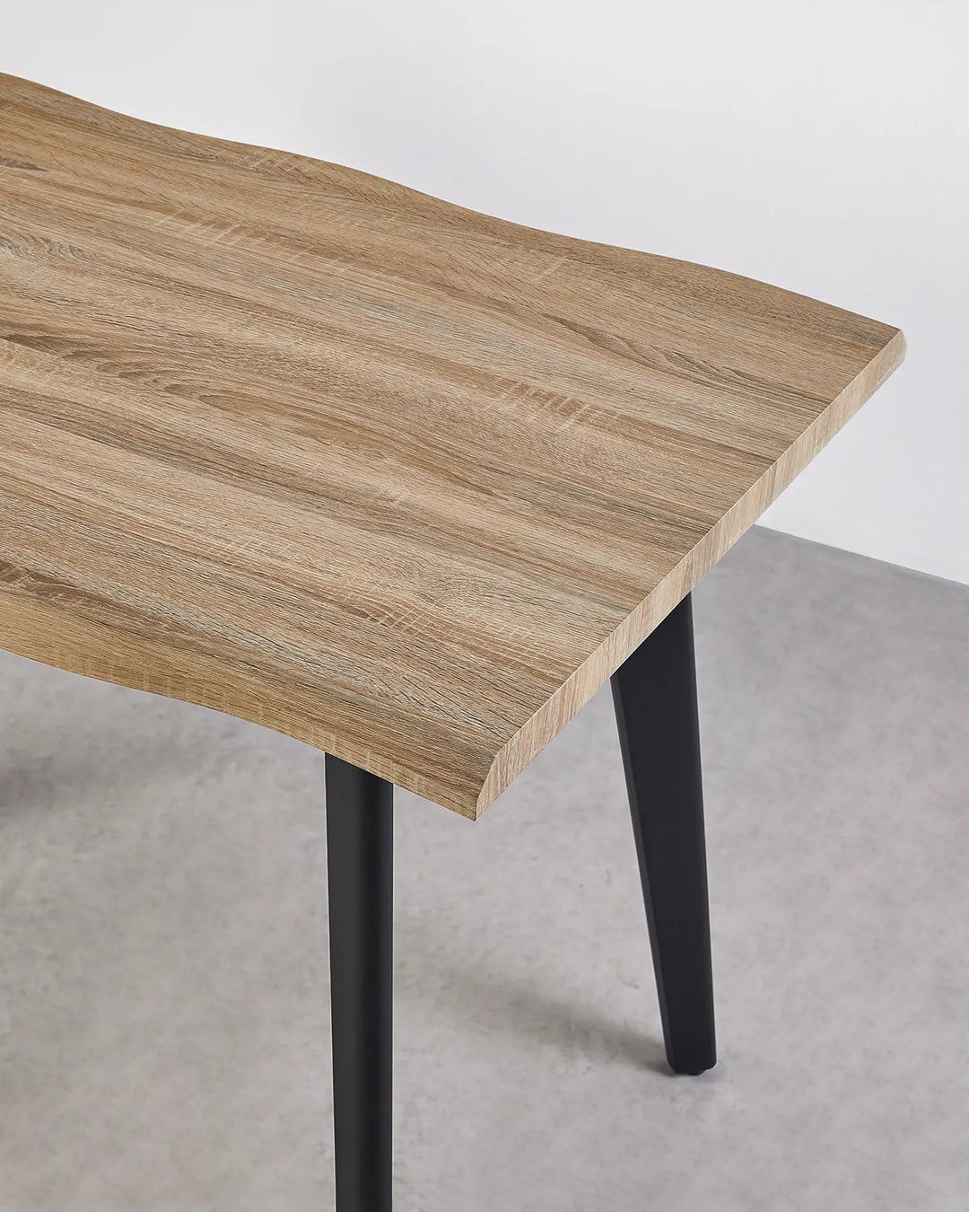 Close-up of the Seibold dining table showing the natural wood grain and organically shaped live edge tabletop