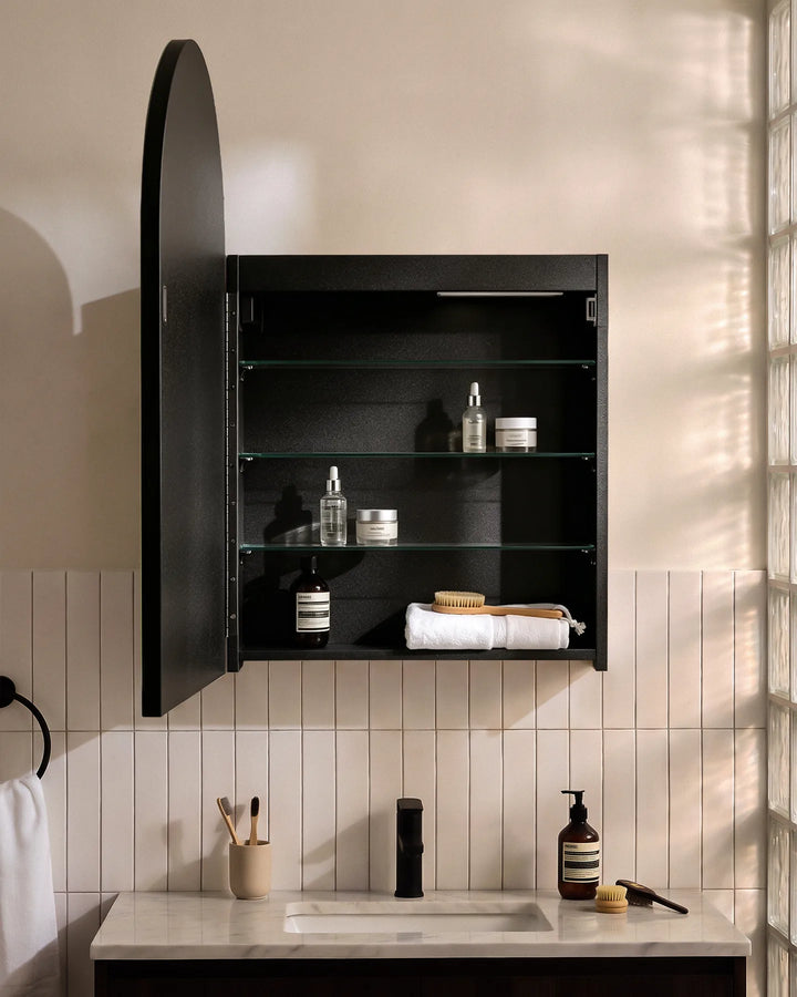 Open black Arcadia arched mirror cabinet showing spacious glass shelves for toiletries.