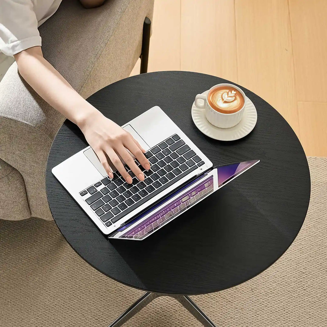 Working on laptop at Vesna black Round Side Table, UK furniture for home office and study spaces