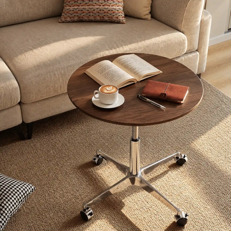Showing a round side table with wheels besids a fofa in a warm living room