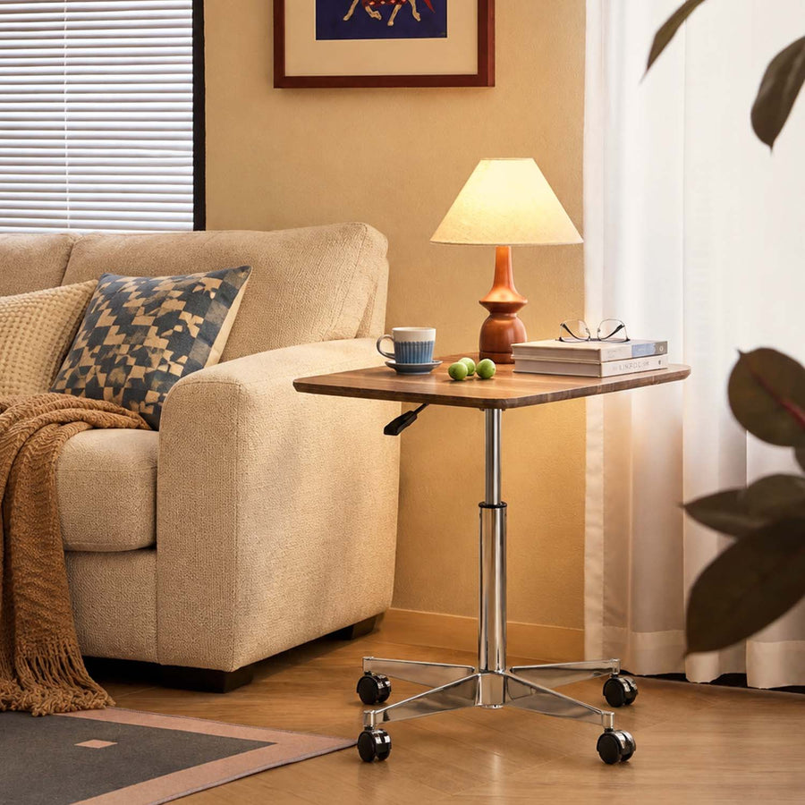 Vesna Square Side Table beside a sofa in a modern living room, featuring castor wheels and a height-adjustable design.