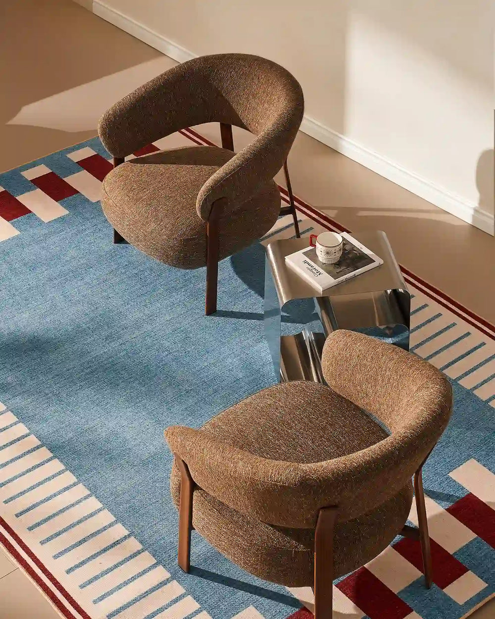 Two Bramley Accent Chairs in walnut facing each other in a modern living room, top view