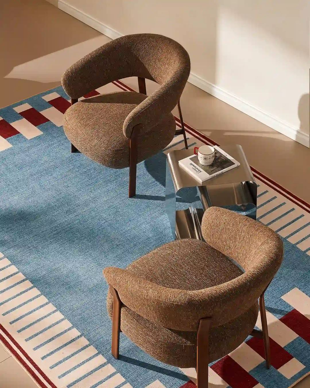 Two Bramley Accent Chairs in walnut facing each other in a modern living room, top view