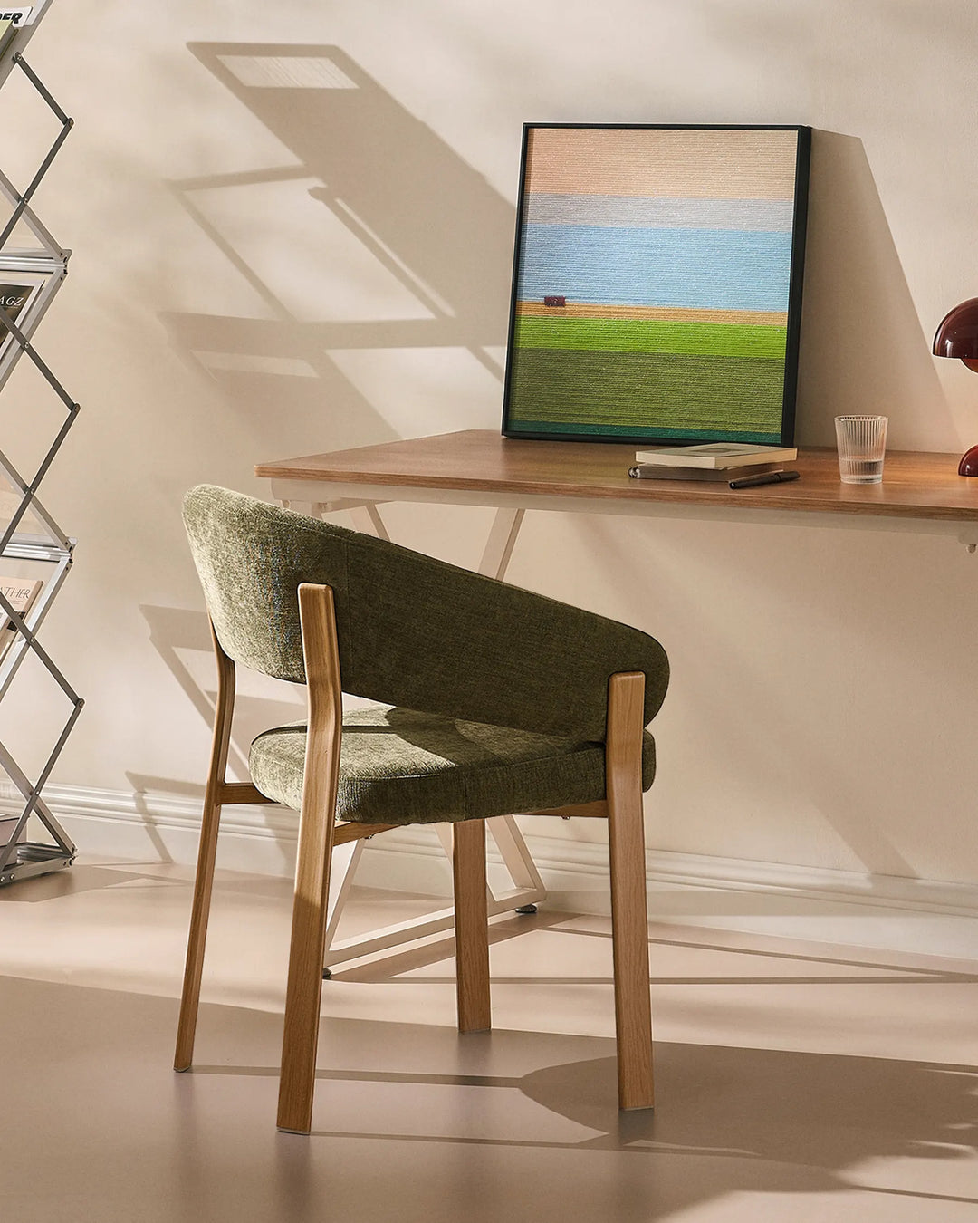 Bramley moss green and oak upholstered armchair used as a rustic desk chair in a relaxed home office
