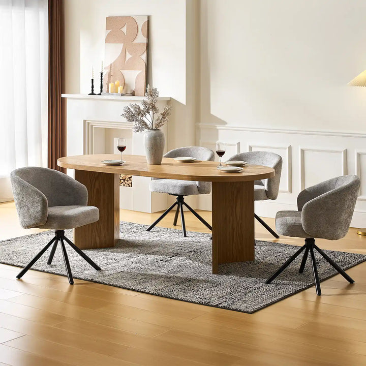 Four Cleo Grey Swivel Chairs around a dining table in a bright dining space
