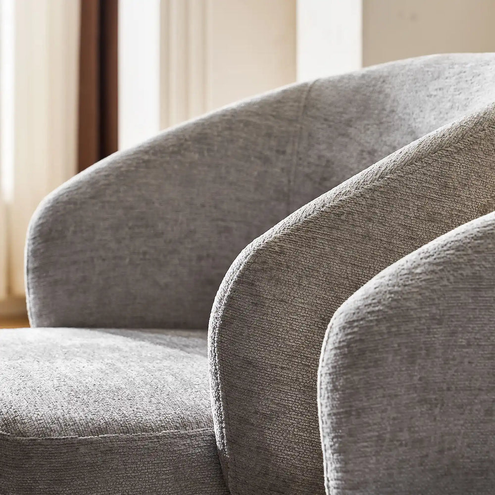 Curved armrest and soft grey chenille fabric of Cleo Grey Swivel Chair