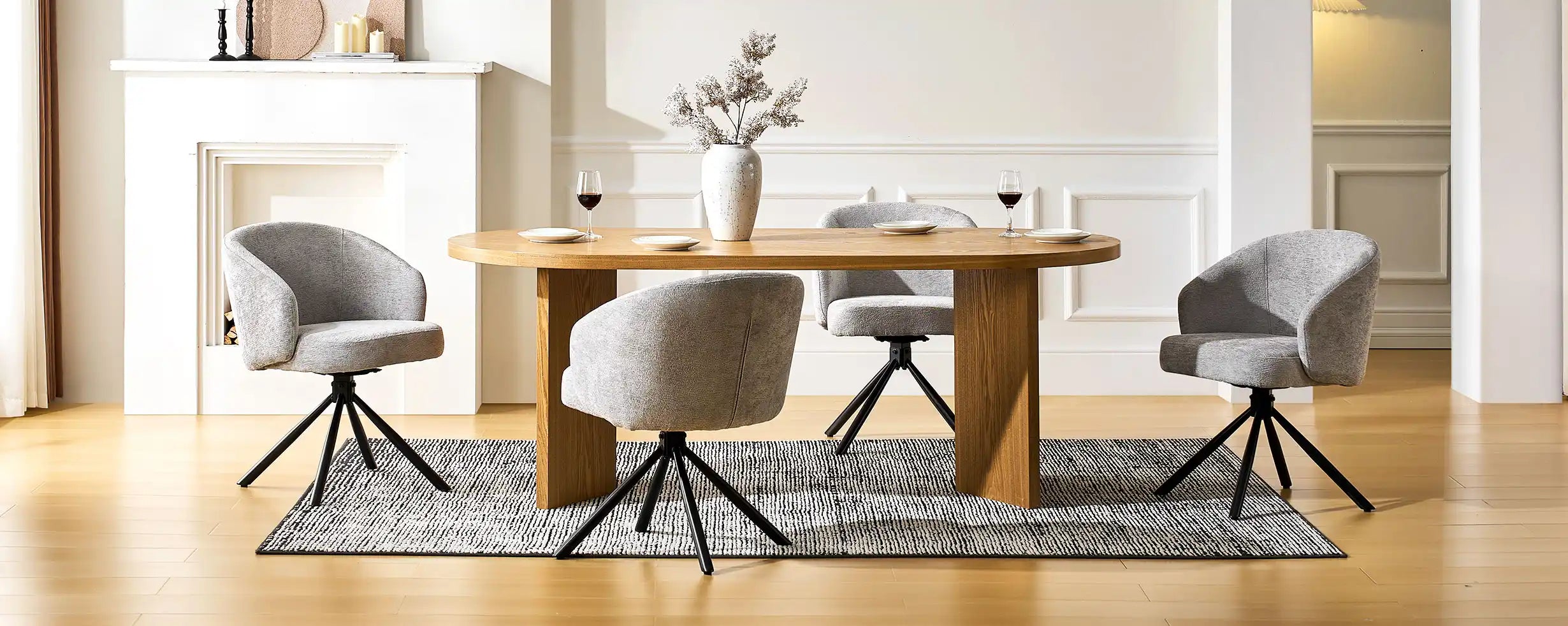 Four Cleo Grey Swivel Chairs around a dining table in a bright dining space