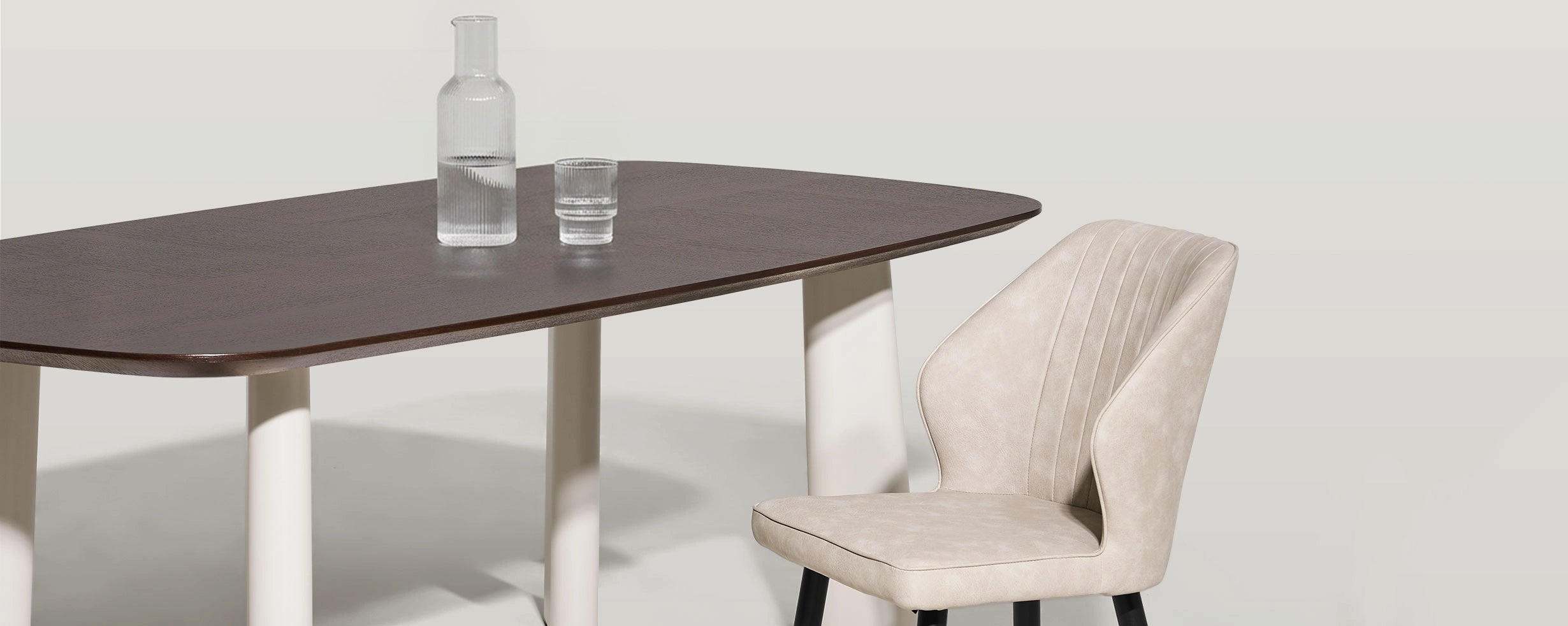 Close-up of Danforth walnut veneer tabletop and beige metal legs showing material contrast