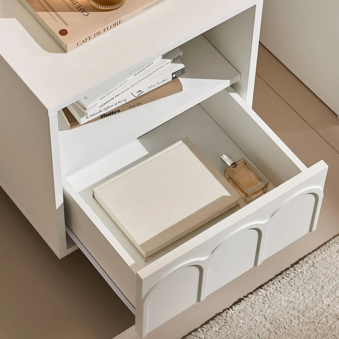 Top view of Doris Bedside Table with drawer open, showing books and perfume inside, offering spacious and convenient bedside storage.