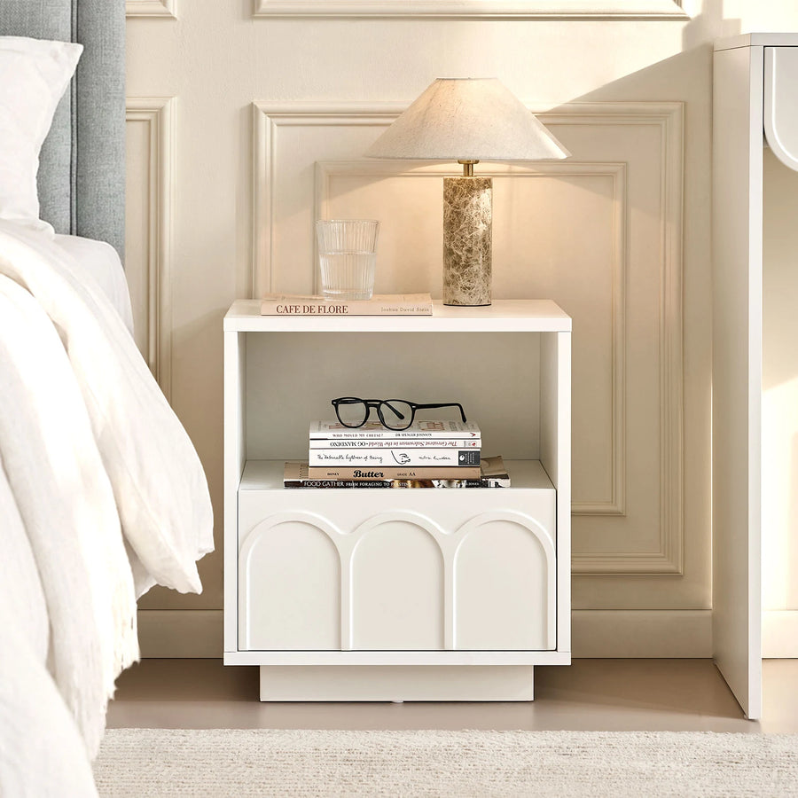 Doris Bedside Table is placed between the bed and Doris dressing table, storing everyday bedside essentials, with a table lamp on top for practical bedroom use.