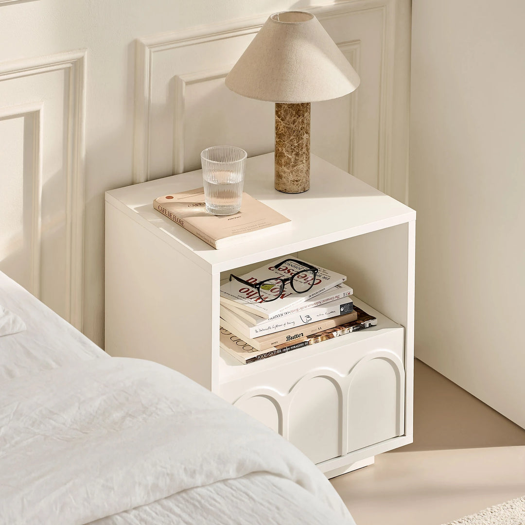 Doris Bedside Table is styled beside the bed, creating a cosy and inviting bedroom atmosphere.