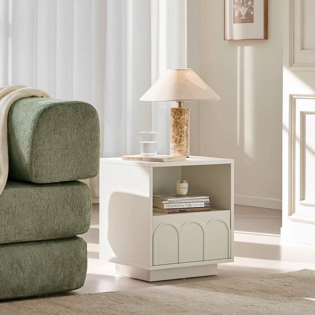 Doris Side Table styled next to a sofa, adding a light and contemporary touch to the living room.