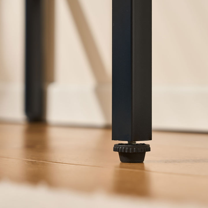 Adjustable foot pads on the legs of the Lumie RGB light vanity desk